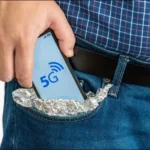 Hình ảnh người đàn ông bọc điện thoại 5G bằng giấy bạc và bỏ vào túi, minh họa cho nỗ lực chặn tín hiệu không dây.