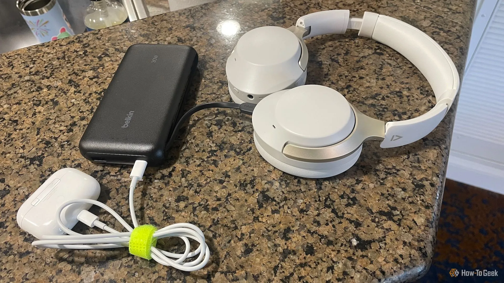 Belkin BoostCharge Power Bank 20K đang sạc tai nghe không dây và hộp AirPods Pro