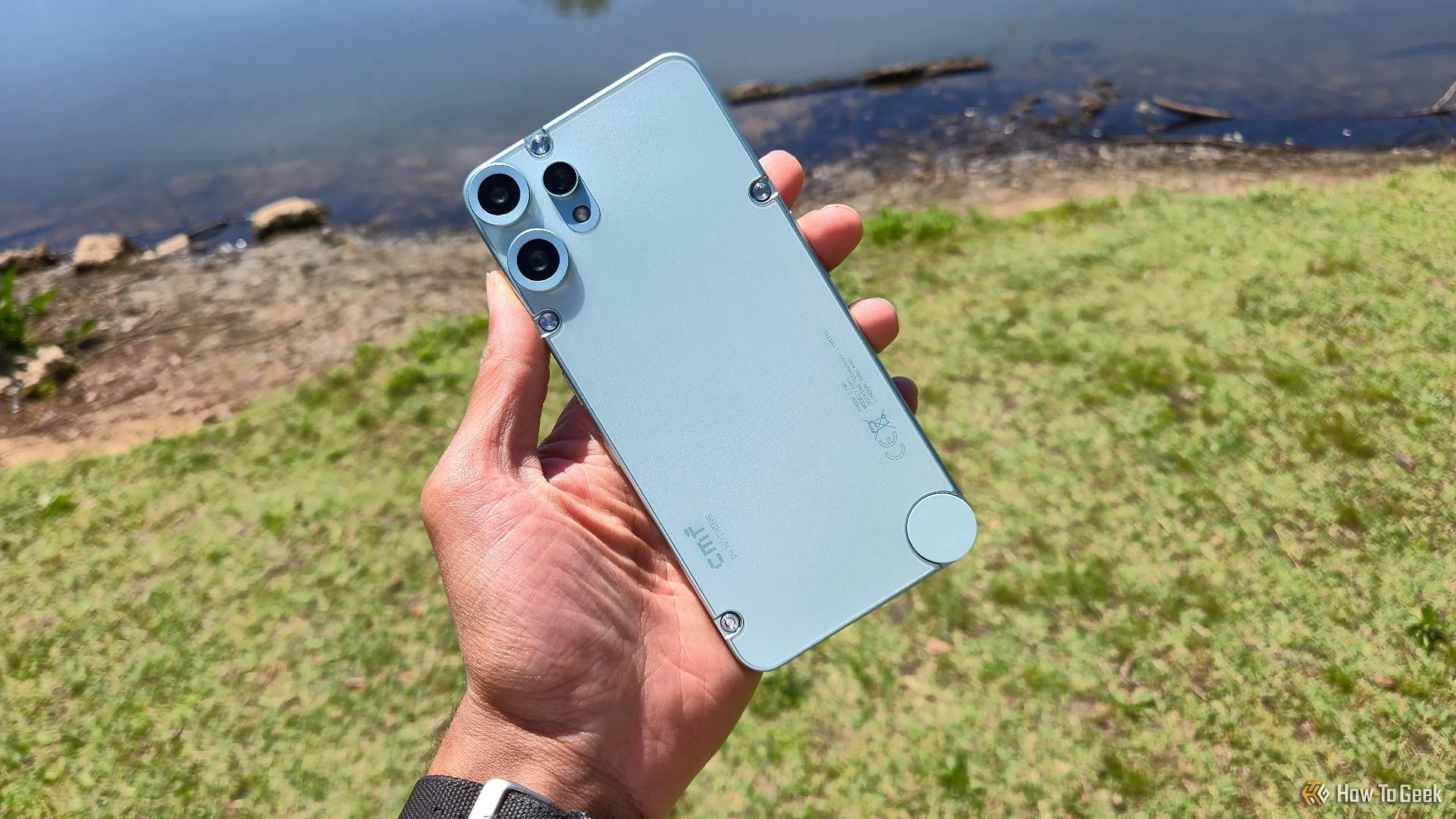 Điện thoại CMF Phone 2 Pro với thiết kế đặc trưng, đặt trước khung cảnh hồ nước