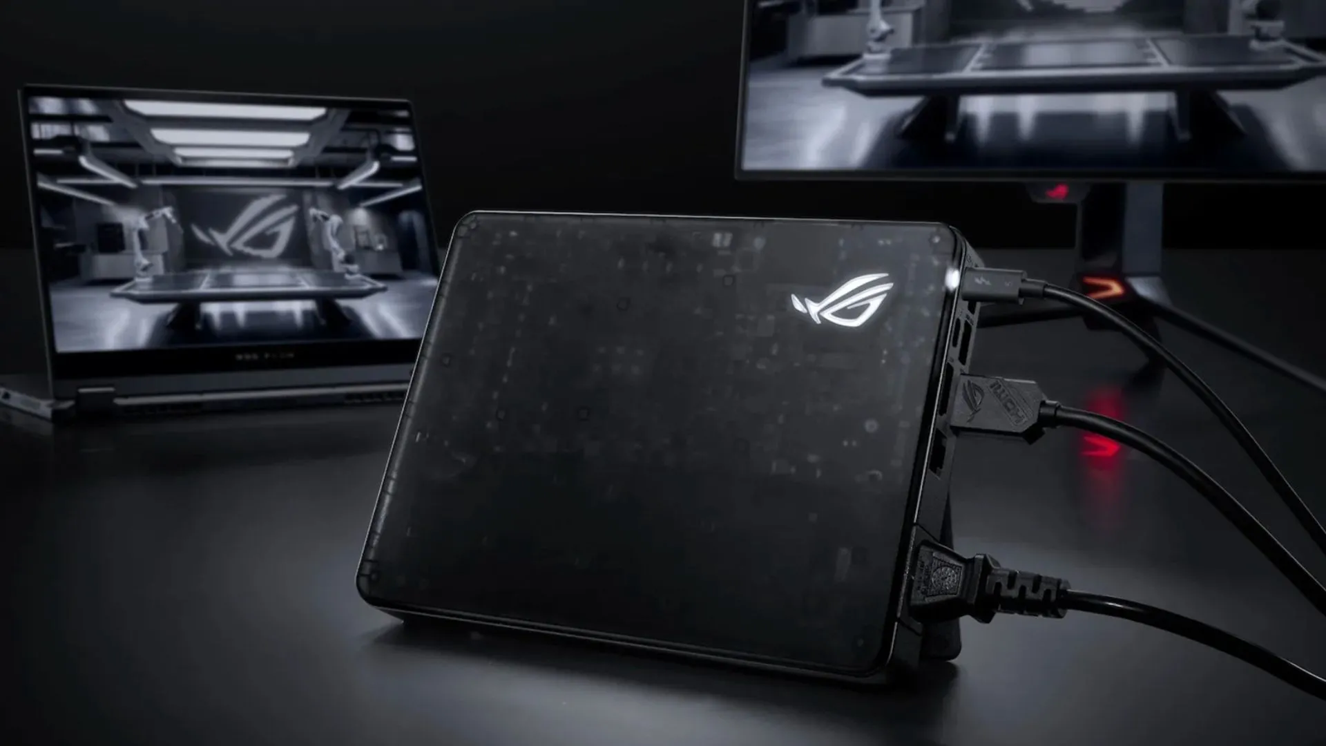 eGPU ASUS ROG XG Mobile 2025 kết nối với laptop và màn hình ngoài, thể hiện giải pháp đồ họa di động cao cấp.